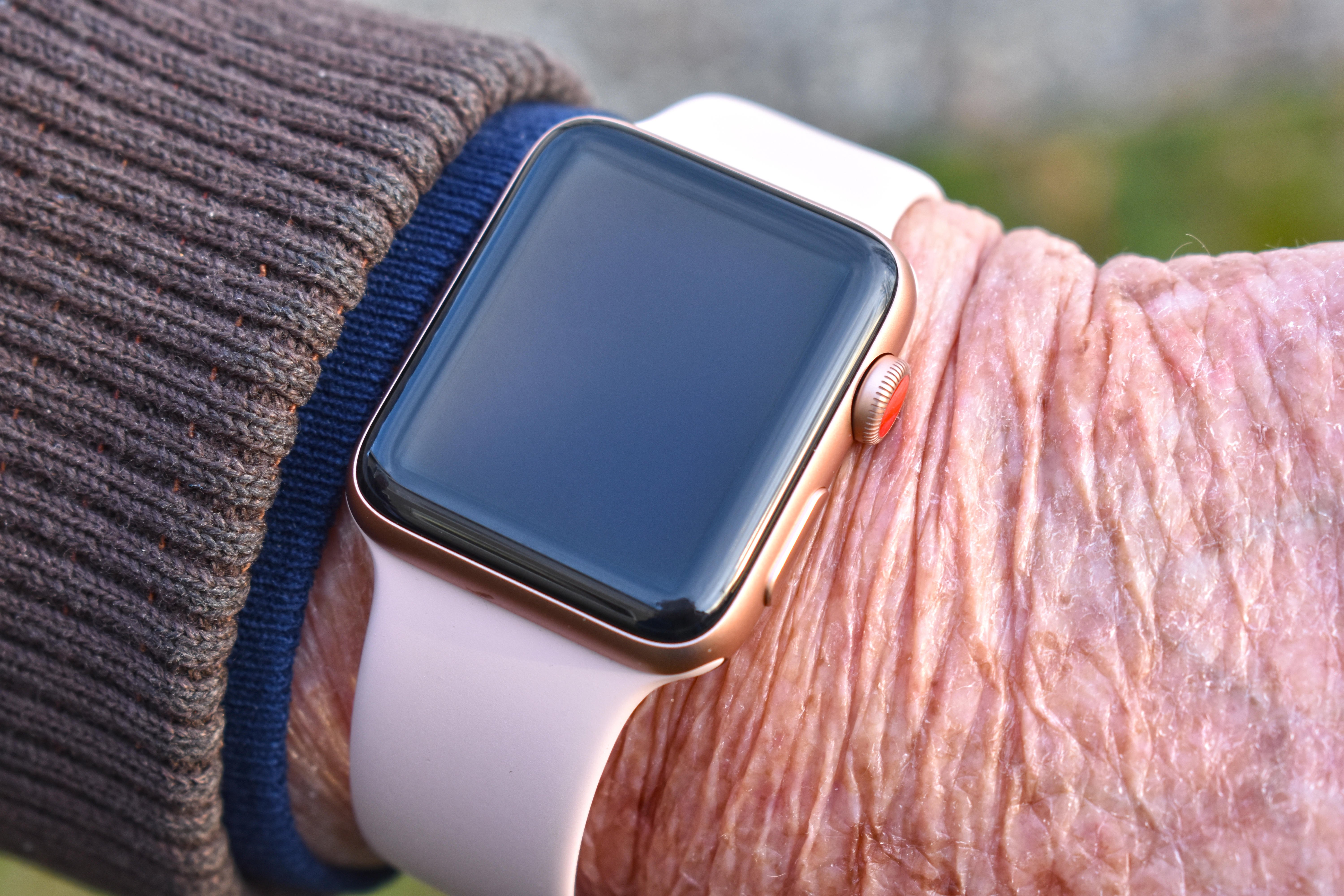 A closeup photograph of an Apple Watch on the wrist of an older woman.