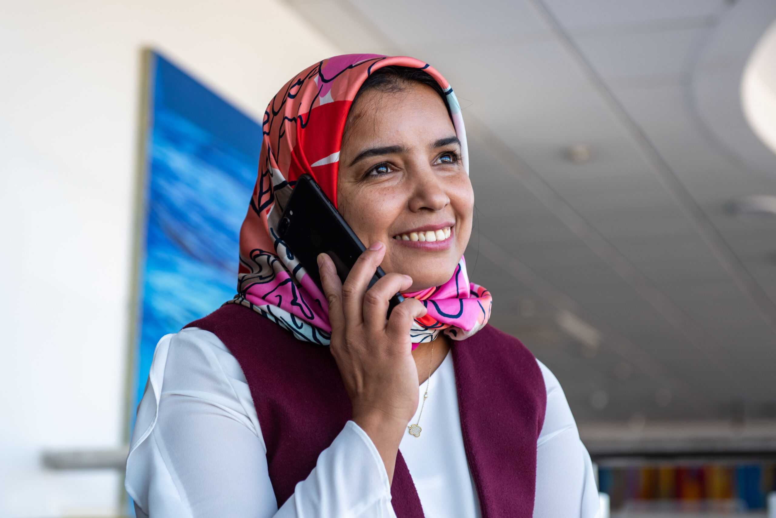 Lady smiles as she's on a phone call