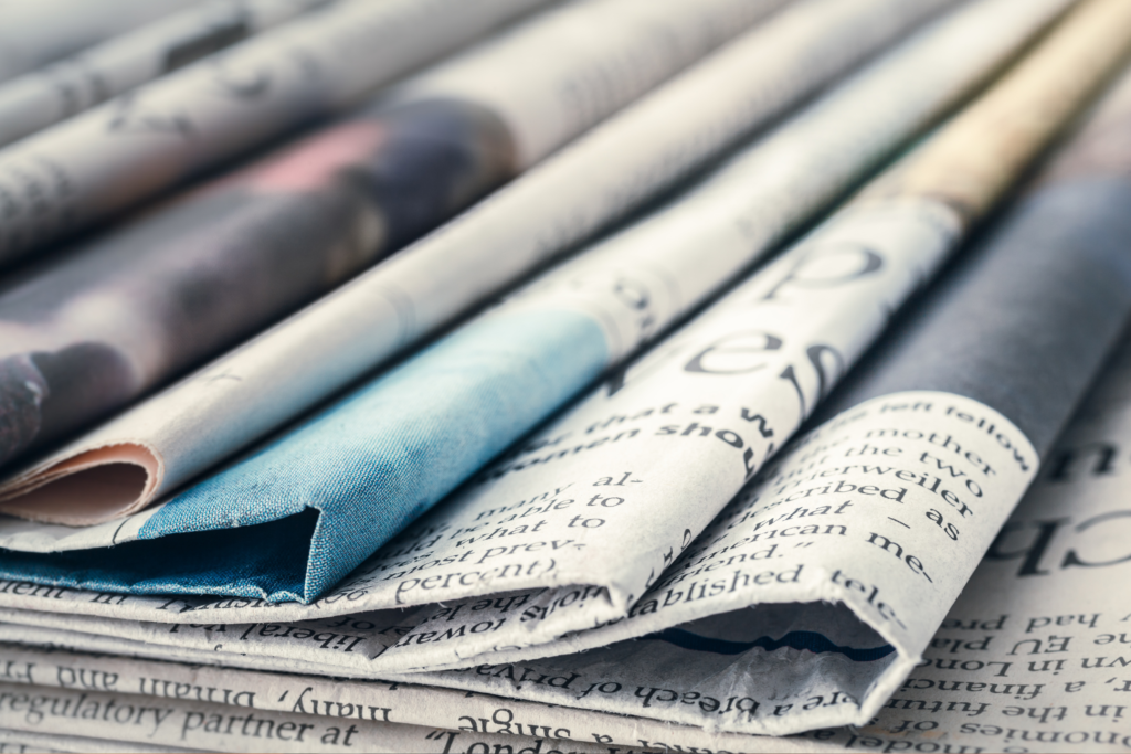 A photograph of a stack of newspapers